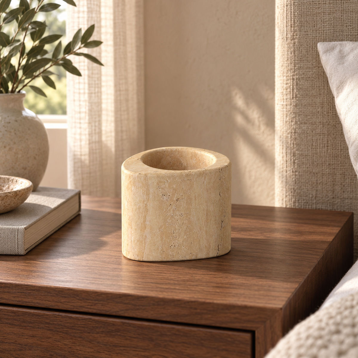 SwanEgg candle holder, Tall Italian Classico Travertine, one holder, low front view in a warm naturally lit interior