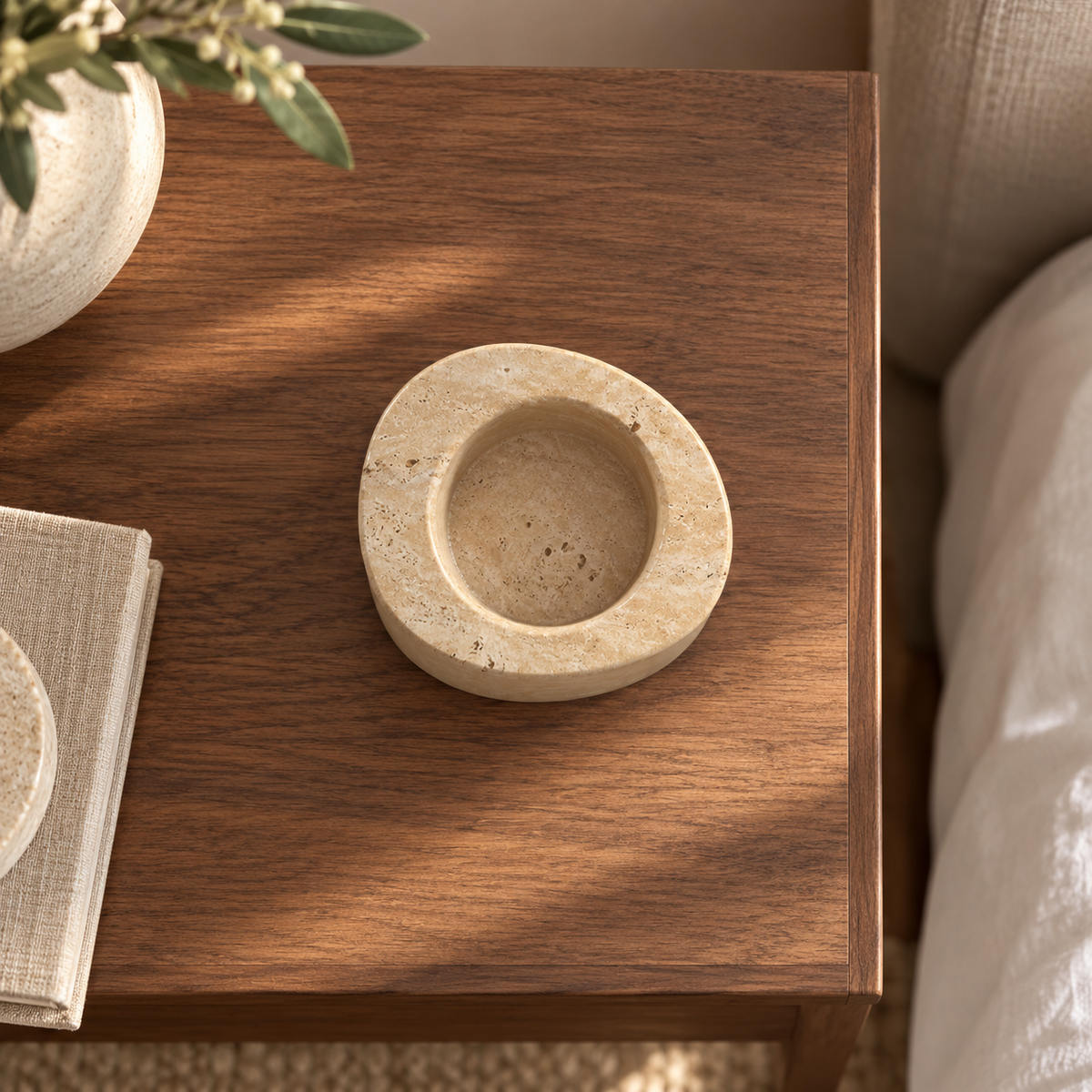 SwanEgg candle holder, Tall Italian Classico Travertine, one holder, overhead view in a warm naturally lit interior