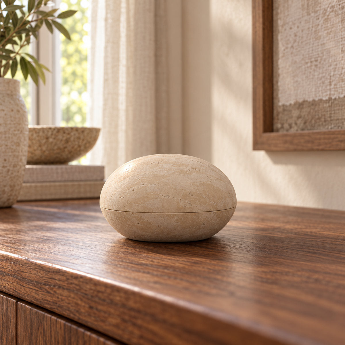 ZenPebble Marble Decor, Italian Classico Travertine, one closed ornament, low end-on view in a warm naturally lit interior