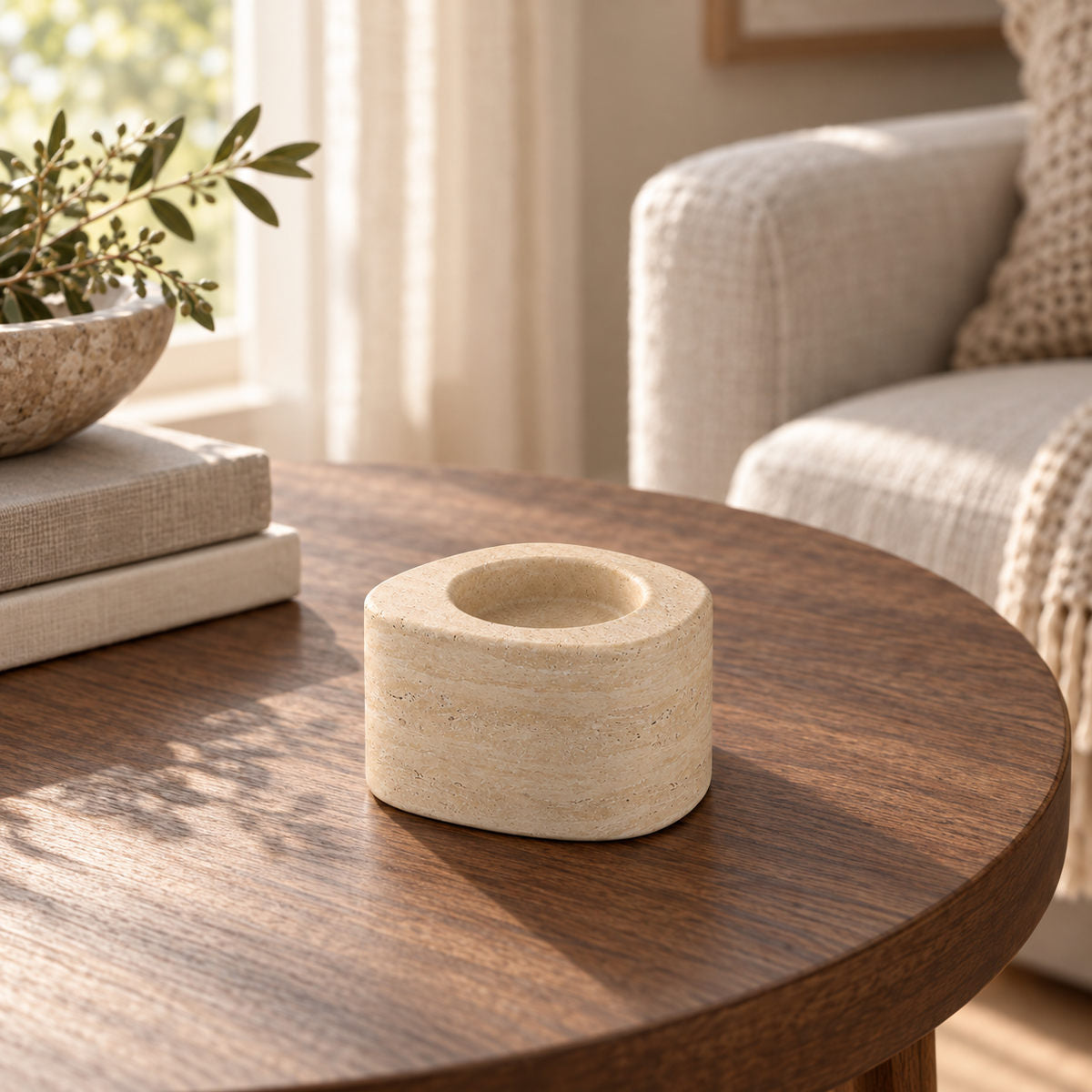 ZenPebble Candle Holders, Italian Classico Travertine / Short, single configuration, left oblique view in a warm naturally lit interior