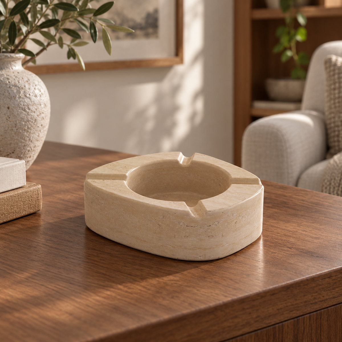 ZenPebble ashtray, Italian Classico Travertine, single ashtray with four rim rests, low front view in warm natural light