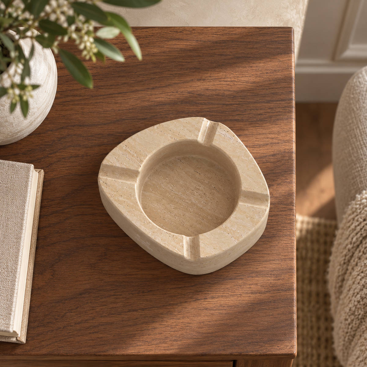 ZenPebble ashtray, Italian Classico Travertine, single ashtray with four rim rests, overhead view in warm natural light