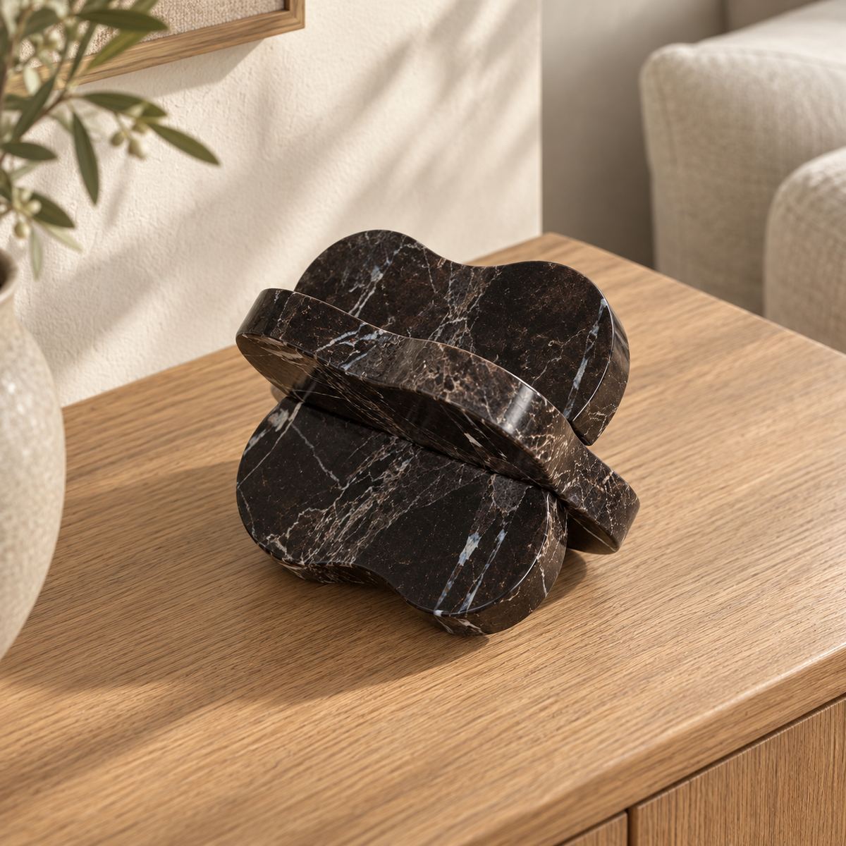 LakeMist Marble Decor, dark Emperador marble, high left three-quarter, in a warm oak and linen interior