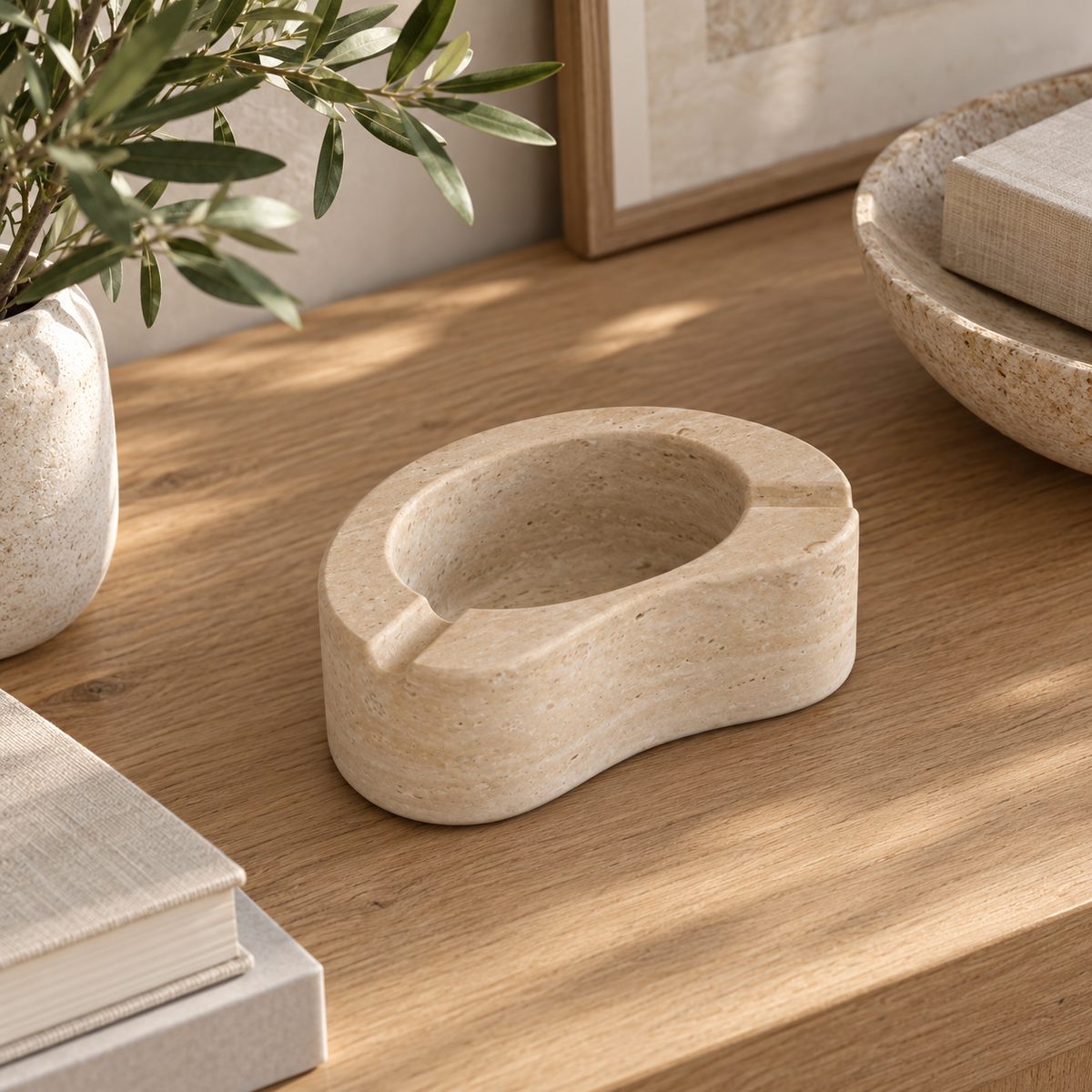PeaPod Marble Ashtray, high left bean ashtray three-quarter, warm natural light in a premium home interior