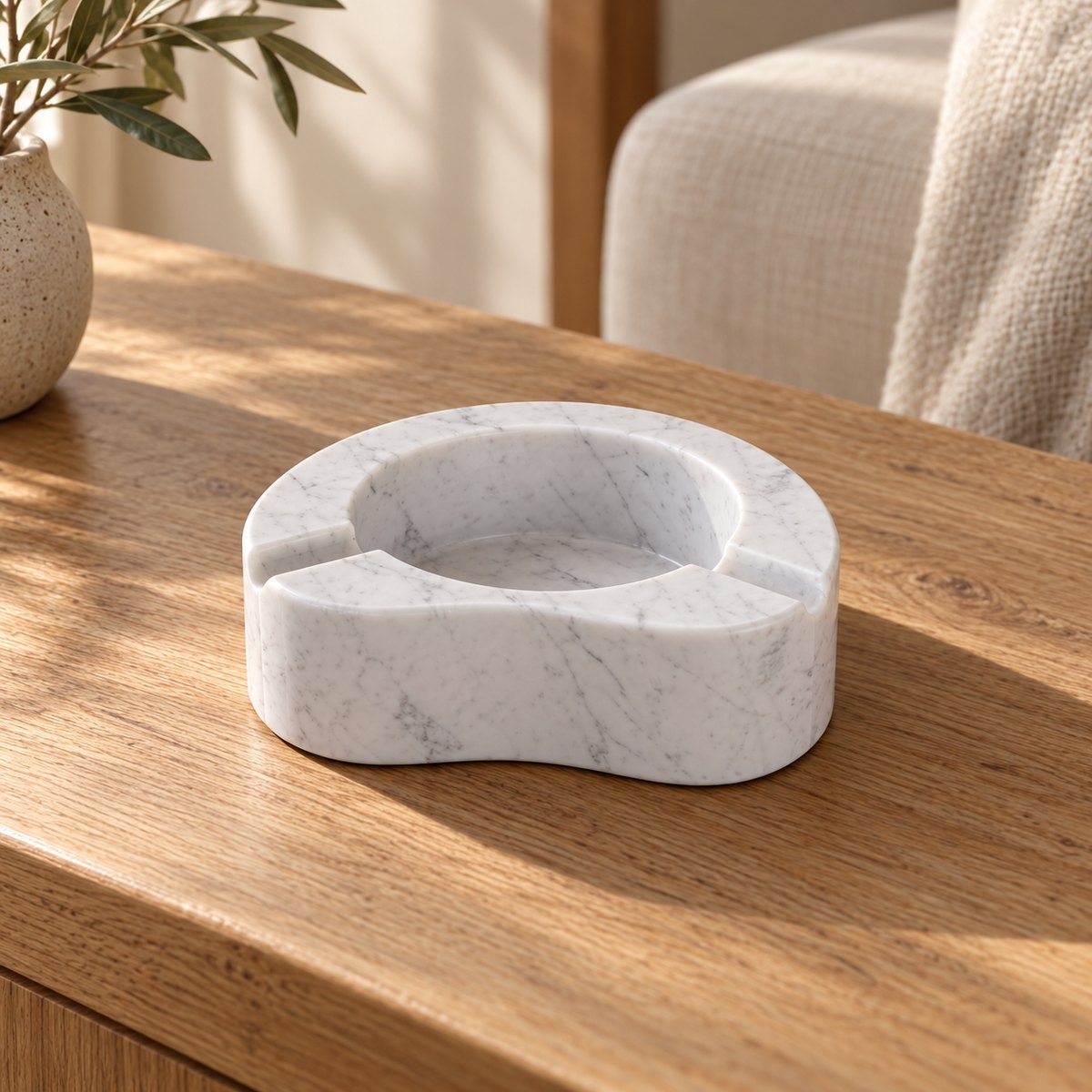 PeaPod Marble Ashtray, Italian Carrara Marble, single configuration in a warm naturally lit oak interior