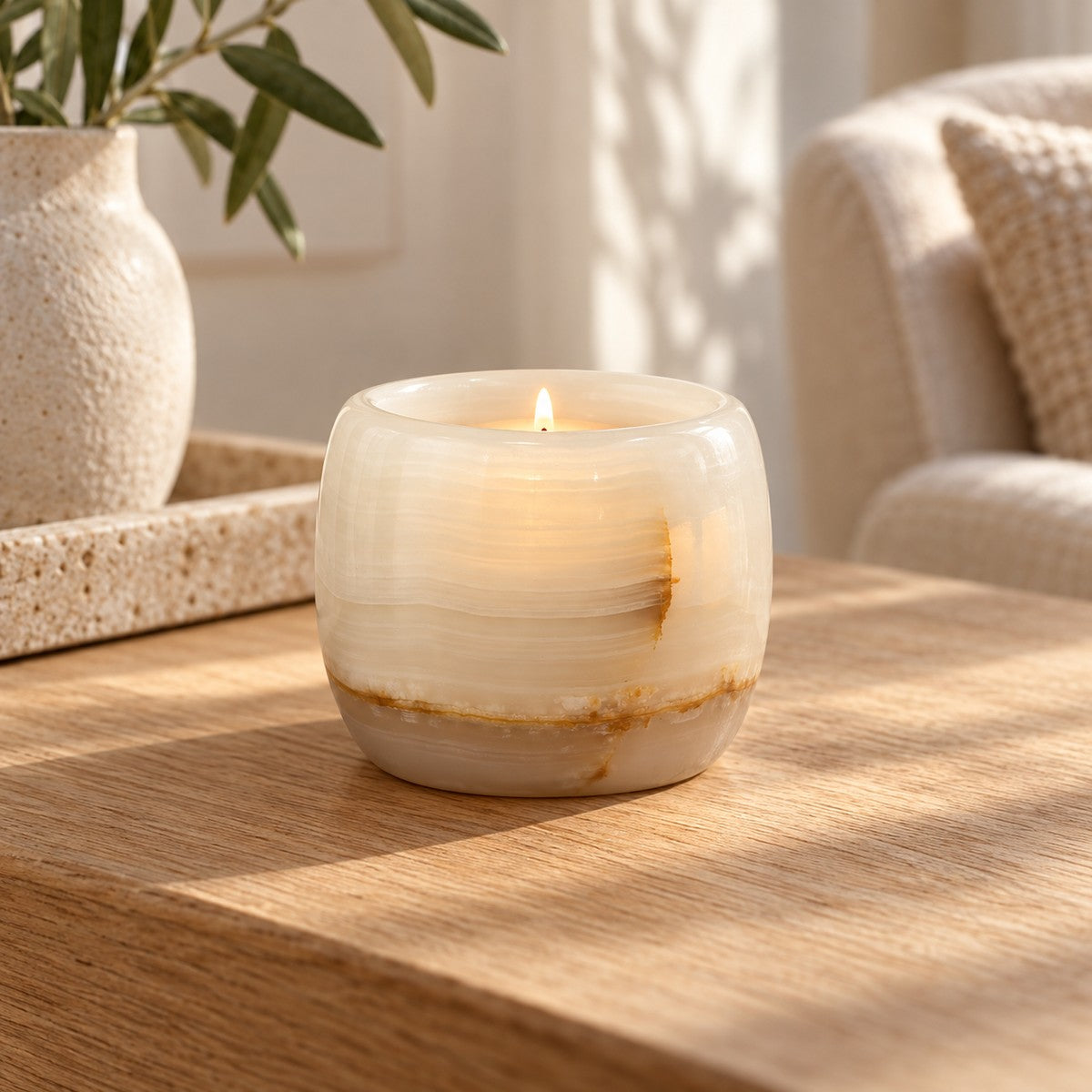 Luxury Lumi White Onyx Candle Holder, low frontal white-onyx Lumi Hero, warm natural light in a premium home interior