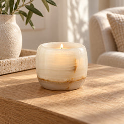 Luxury Lumi White Onyx Candle Holder, low frontal white-onyx Lumi Hero, warm natural light in a premium home interior