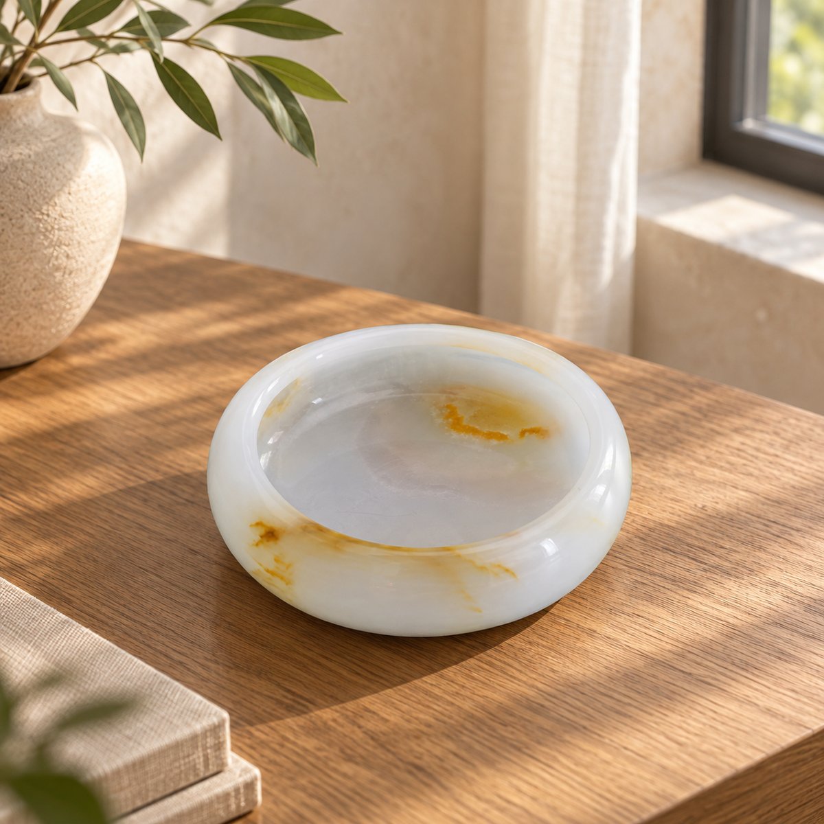 Aura Round Onyx Ashtray, high left Aura round bowl, warm natural light in a premium home interior