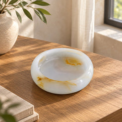 Aura Round Onyx Ashtray, high left Aura round bowl, warm natural light in a premium home interior