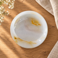 Aura Round Onyx Ashtray, overhead Aura round bowl, warm natural light in a premium home interior