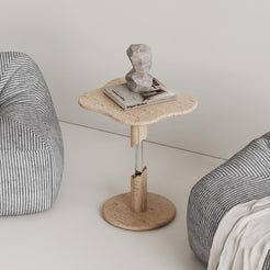 AeroCloud Travertine Side Table from OIXDESIGN placed between two single sofas, styled with a book and stone decor on top.