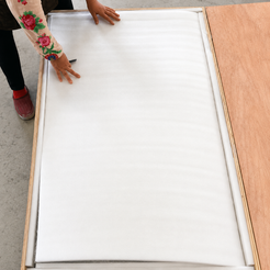 AquaFlow coffee table protected with fitted foam layers inside its custom wooden shipping crate