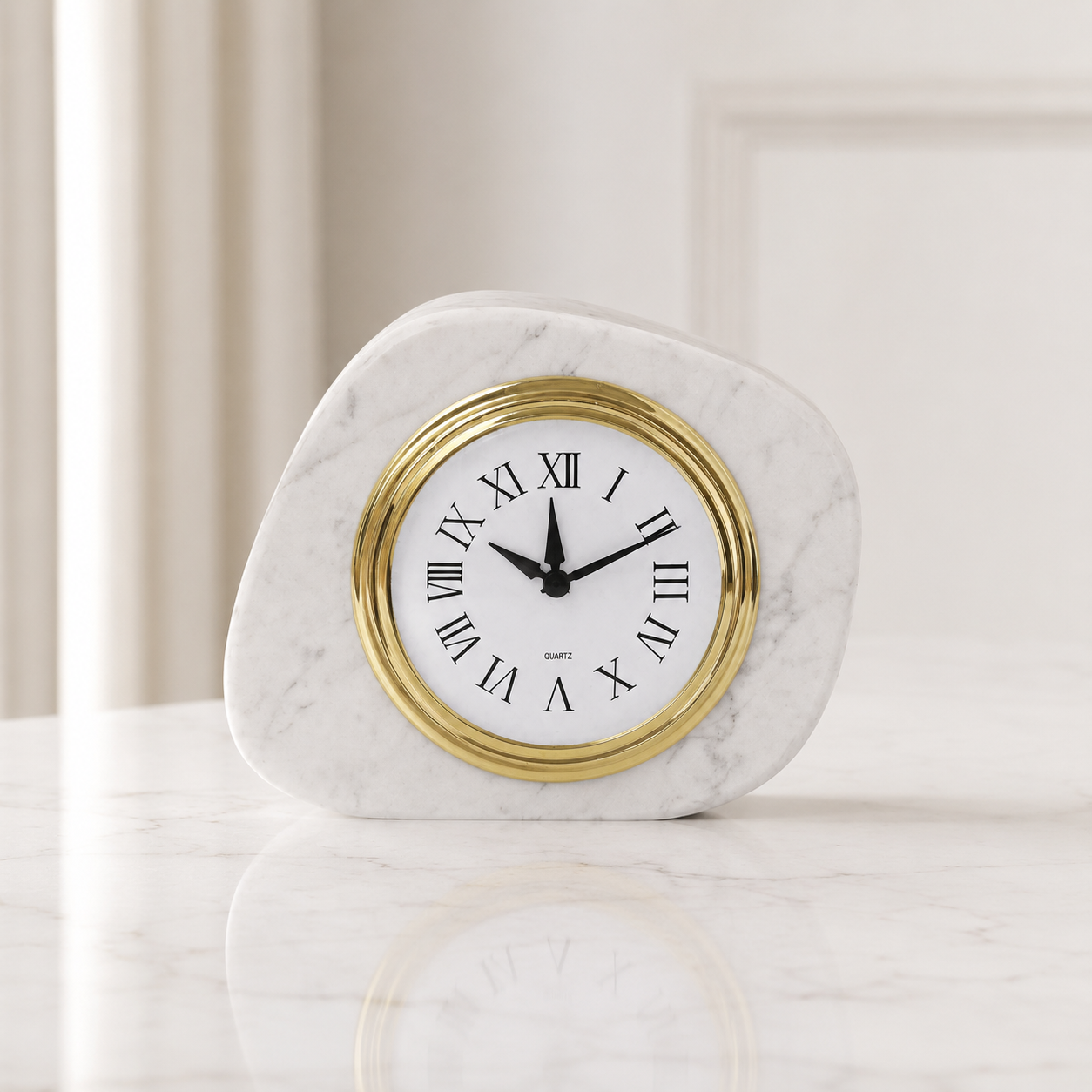Carrara white marble clock in front view with gold bezel and Roman numeral dial
