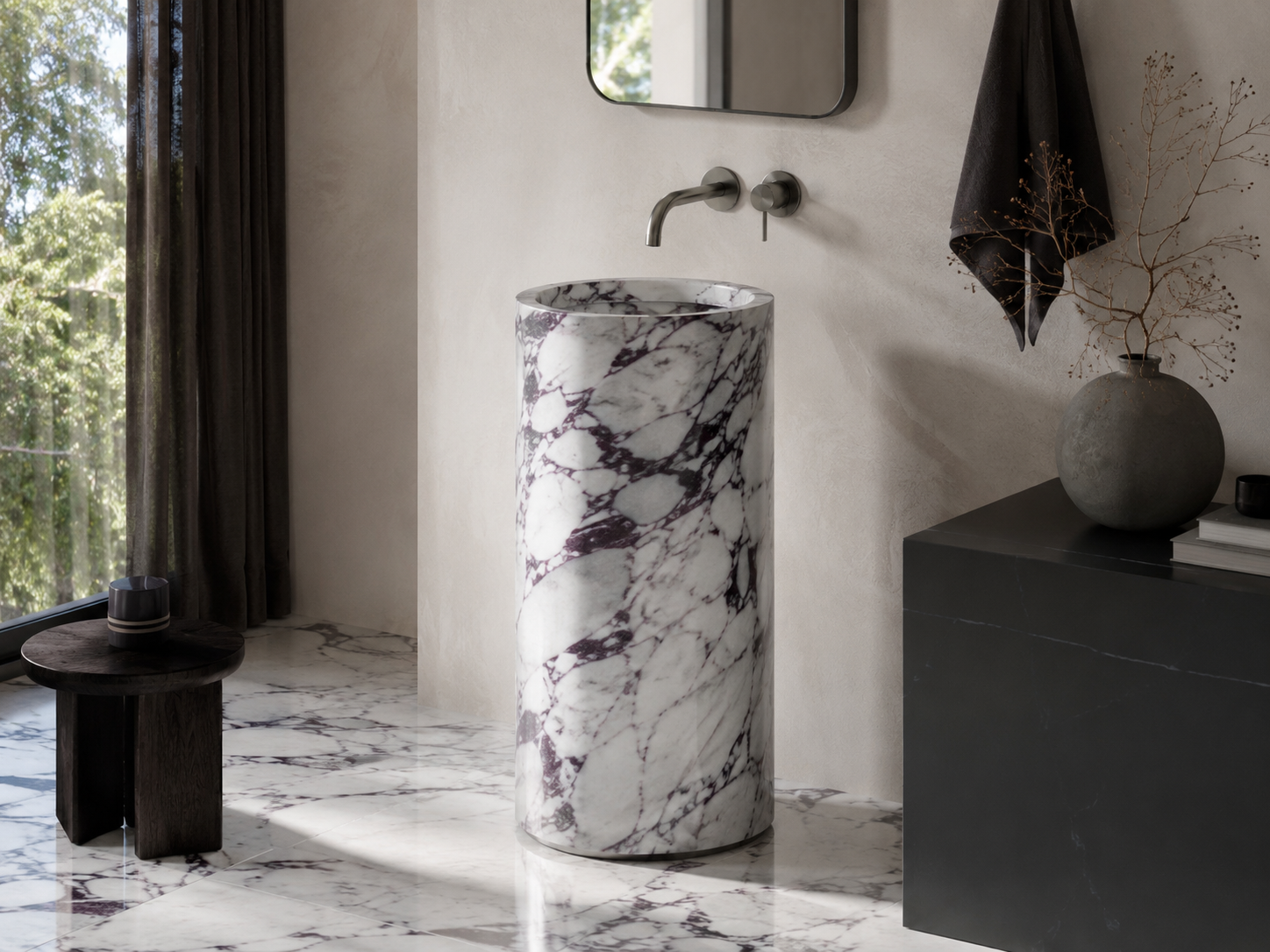 Freestanding natural stone pedestal sink creating a sculptural focal point in a refined bathroom interior by OIXDESIGN