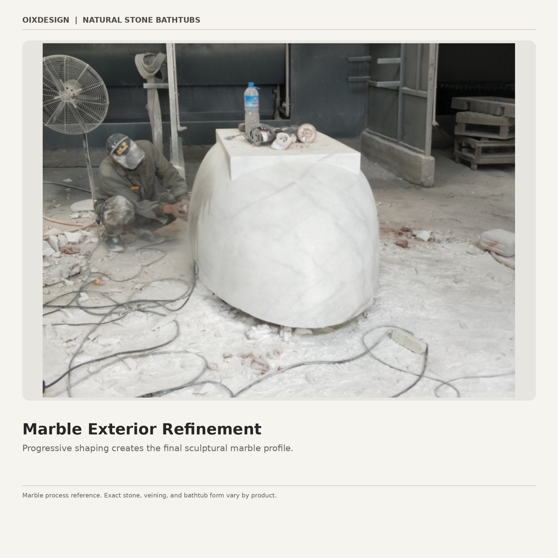 Stone artisan refining the exterior profile of a solid marble bathtub