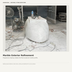 Stone artisan refining the exterior profile of a solid marble bathtub
