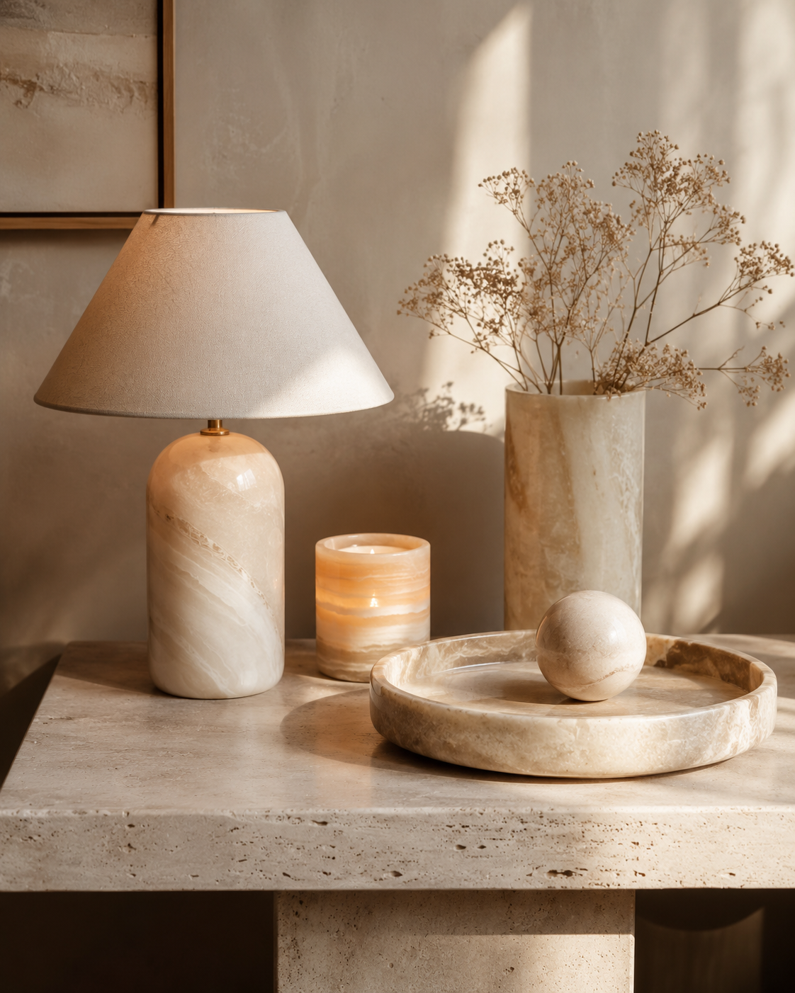 Stone lamp, vase, tray, and candle arranged in a warm interior vignette, representing natural stone decor and lamp care.