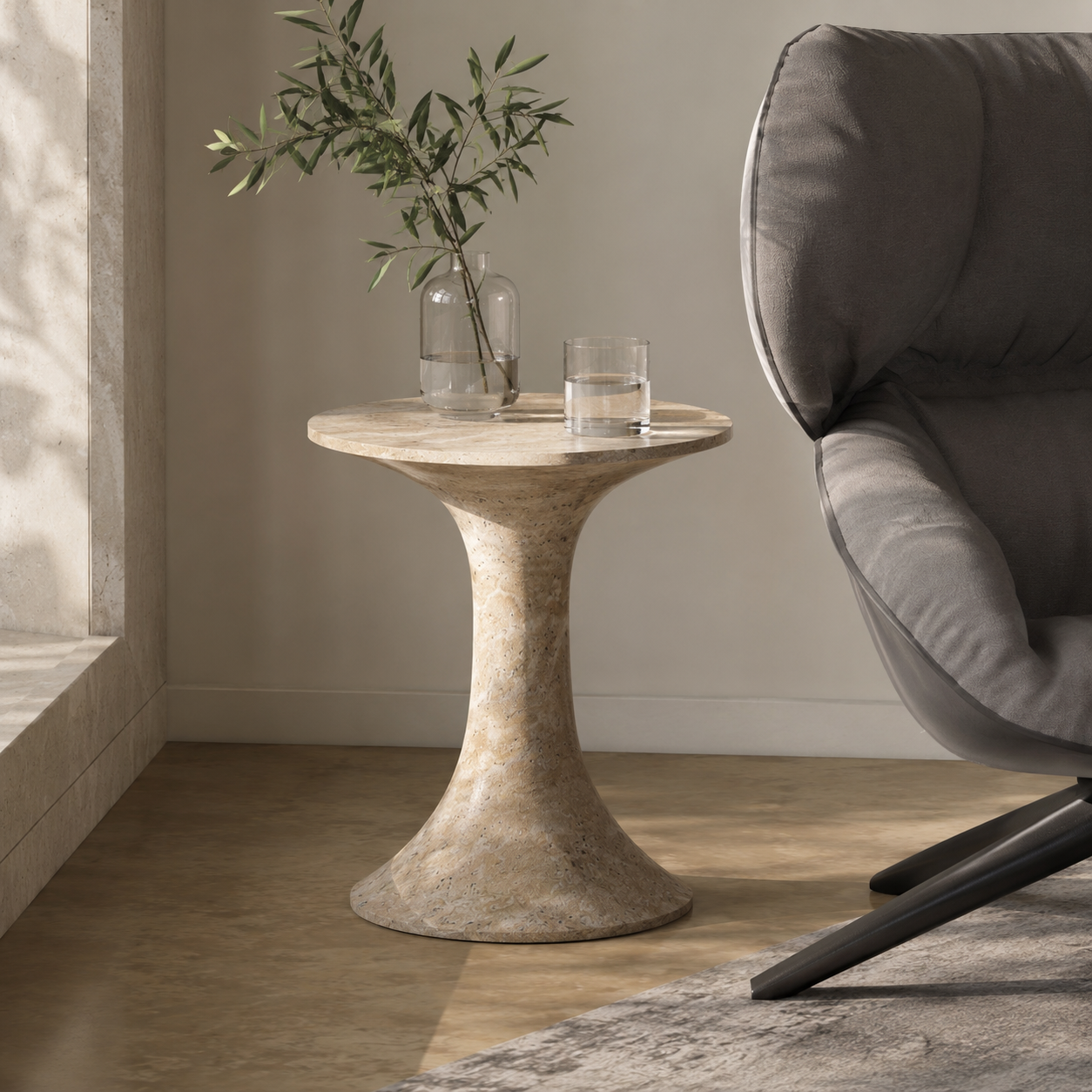 Sculptural stone side table by OIXDESIGN beside a lounge chair in a modern interior