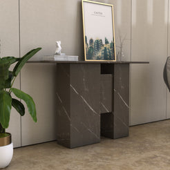 Angled view of the Thalia marble console table showing its long tabletop and carved stone legs