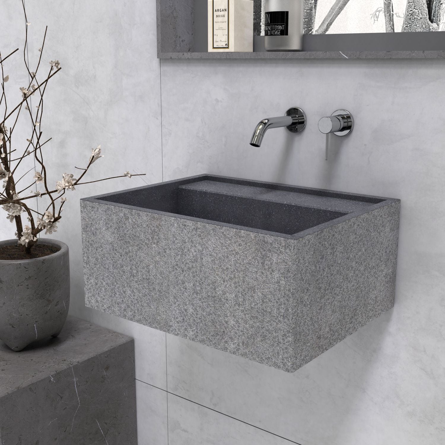 Angled view of the Tibna Neroco stone sink showing its textured front and side