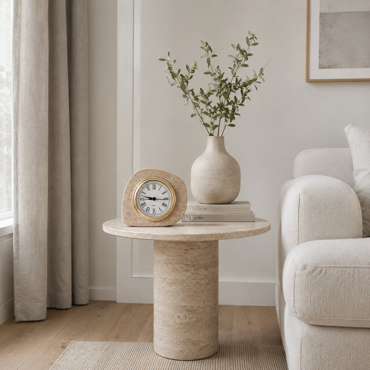 Travertine stone clock styled on a round side table in a soft neutral living room