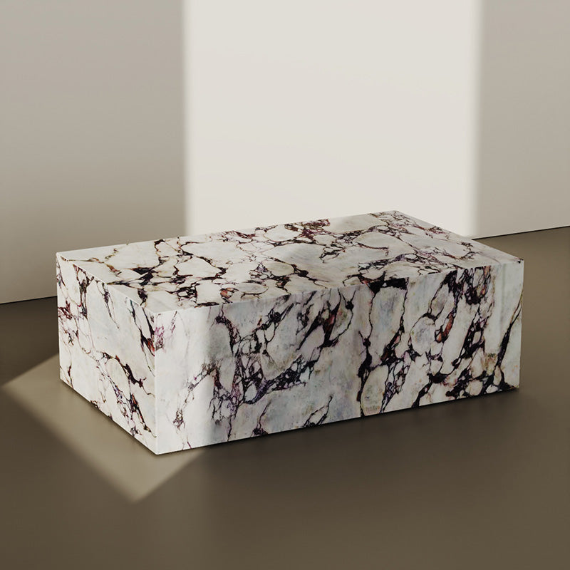 Rectangular marble plinth coffee table crafted from Italian Calacatta Viola marble. Features a bold veined pattern, adding elegance to modern interiors.