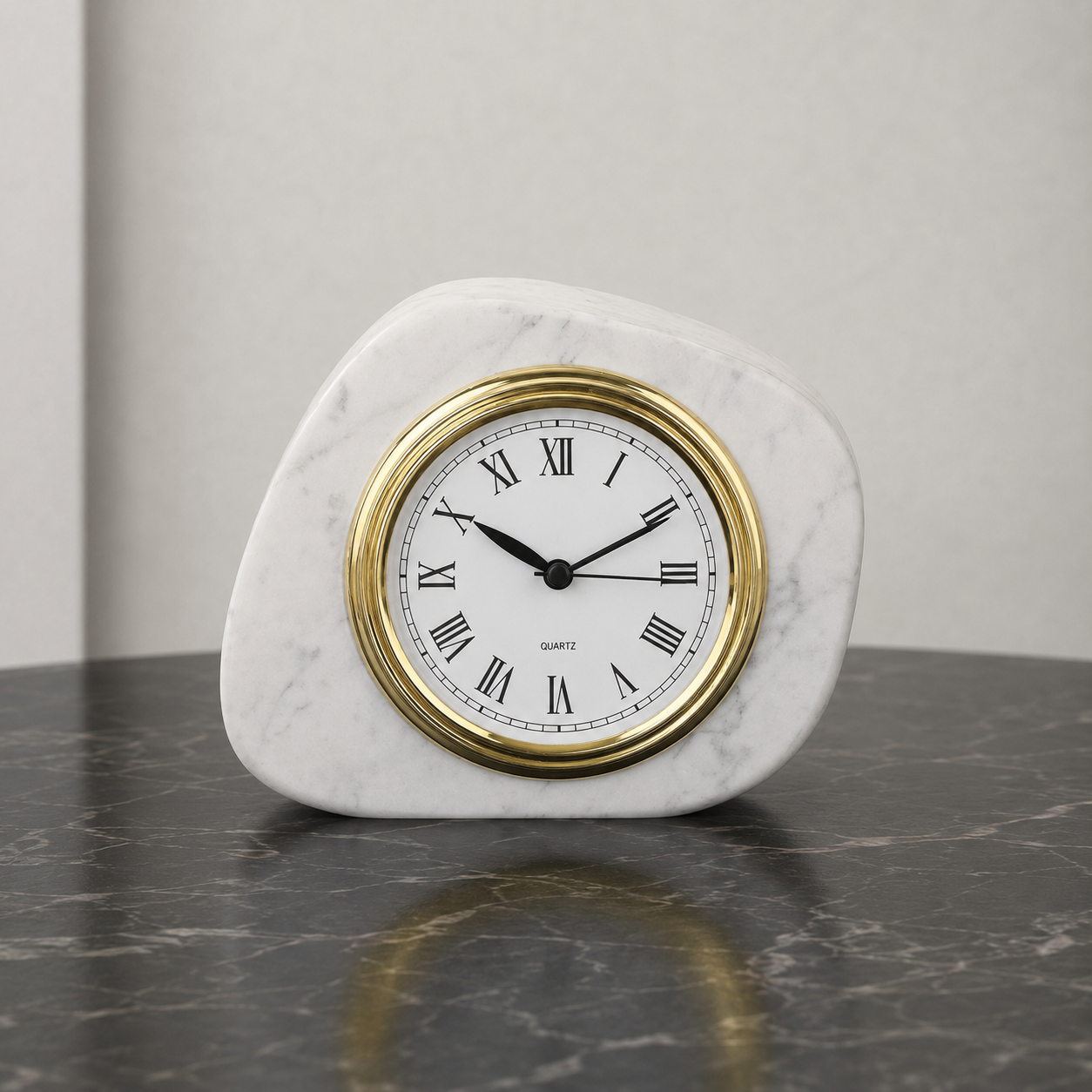 White marble tabletop clock with gold frame styled on a dark stone table