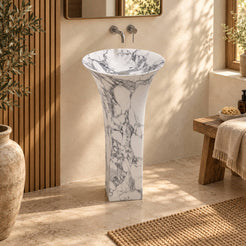 Paka Italian Arabescato Marble Pedestal Sink, full frontal view with square pedestal and flared basin in a warm oak and cream bathroom.