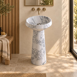 Pala Italian Arabescato Marble Pedestal Sink, frontal view of the circular basin and gently tapered round pedestal in a cream plaster and natural oak bathroom.
