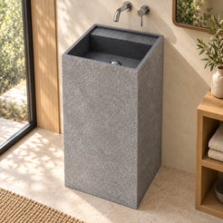 Patala Neroco granite pedestal sink with rectangular basin and rear ledge in a warm ivory and oak bathroom