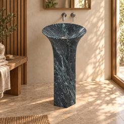 Patia Verderio marble pedestal sink with flared basin and slim carved column in a warm ivory and oak bathroom