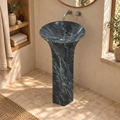 Patia Verderio marble pedestal sink viewed from above in a warm cream bathroom with oak niche and natural daylight