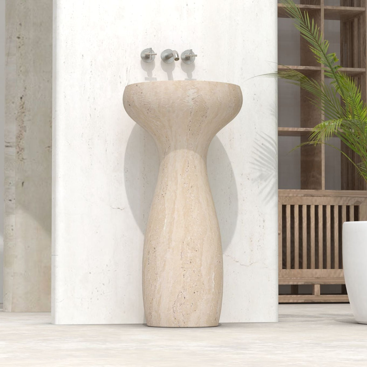 Low front view of the Pava travertine pedestal sink showing its curved column