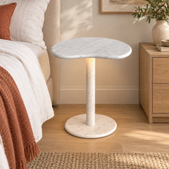 PeaPod Carrara marble smart-edition side table beside a linen bed, shown from a mid-height front view