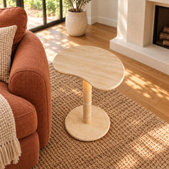 PeaPod Italian Classico travertine smart-edition side table beside a rust linen sofa, shown from a high front-quarter view