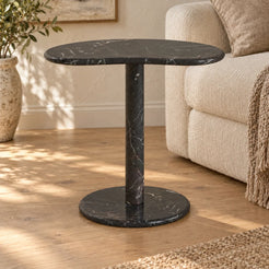 PeaPod Dark Emperador marble side table beside a cream sofa, shown from a low frontal view
