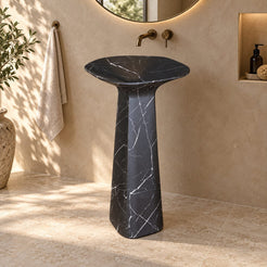 Polona Portoro Black Marble Pedestal Sink — complete rounded-rectangular basin and pedestal in a warm bathroom