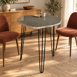 RiverStone natural river stone dining table with black iron hairpin legs in a warm home dining room