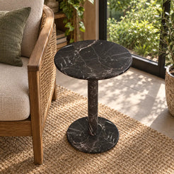 Elevated view of the RoundHaven Dark Emperador marble side table in a garden-window reading corner.
