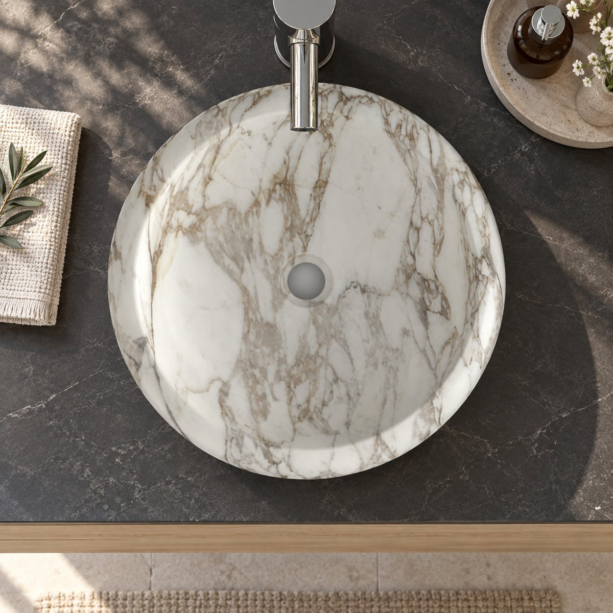 Illustrative overhead bathroom vanity setting showing the Sabino Terista marble basin and central drain