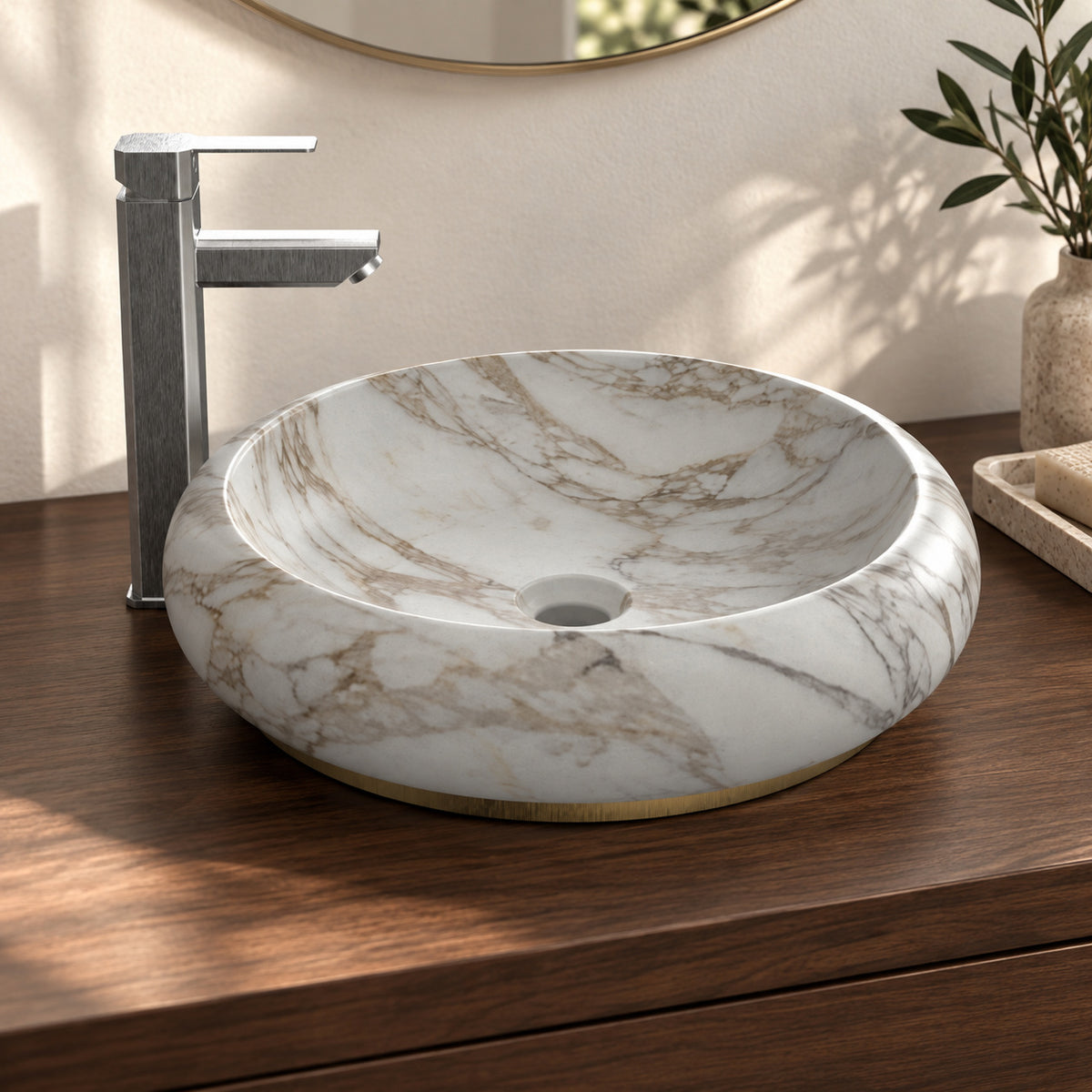 Illustrative walnut vanity setting showing the curved Sabino marble bowl and contrasting base detail