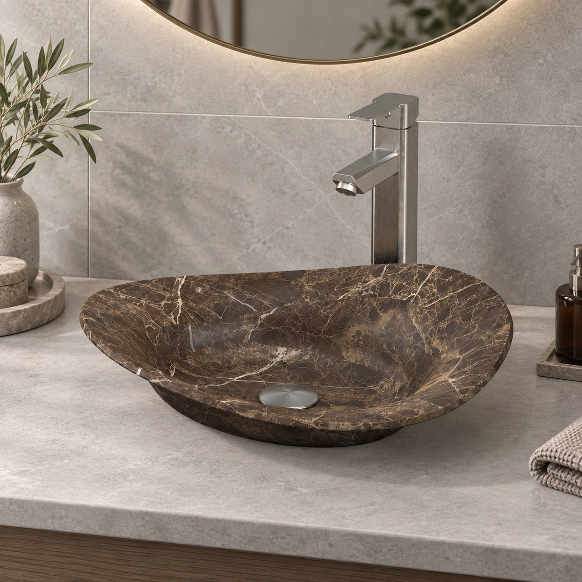 Sabria frontal view of the asymmetric brown marble basin on a grey counter