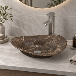 Sabria frontal view of the asymmetric brown marble basin on a grey counter