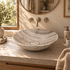 Sadika Travertino Argento vessel sink with three-hole stone drain cover in a sunlit cream bathroom