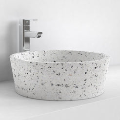 Sauri white terrazzo vessel bowl on a bathroom counter, oblique view