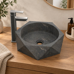 Secca bluestone vessel sink, faceted exterior and round basin, on a countertop, hero lifestyle view
