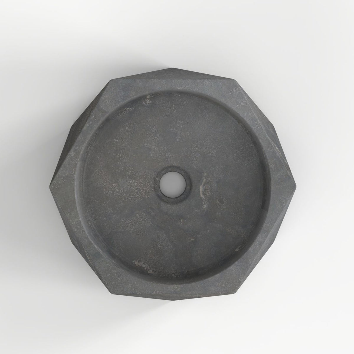 Secca bluestone vessel sink, faceted exterior and round basin, showing the basin interior, material and drain area