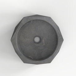 Secca bluestone vessel sink, faceted exterior and round basin, showing the basin interior, material and drain area