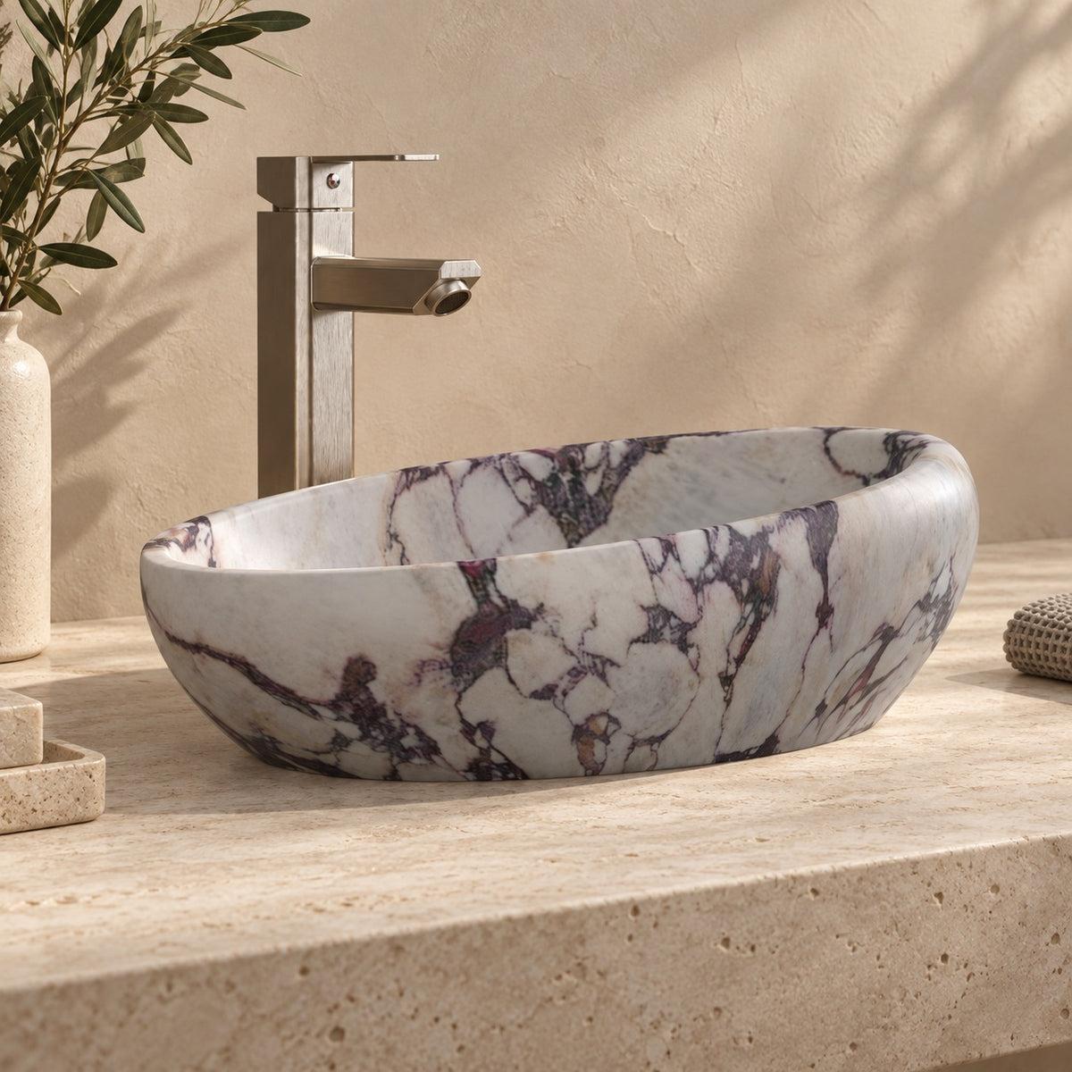Selema Calacatta marble vessel sink, asymmetric oval bowl, on a countertop from a second angle