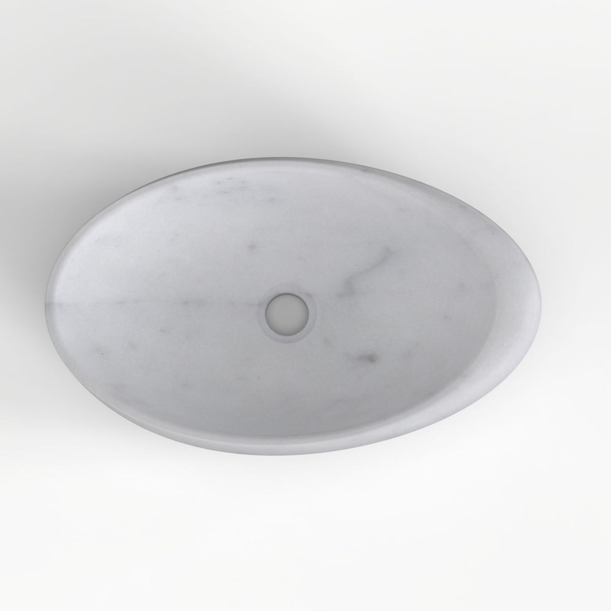 Selema Carrara marble vessel sink, asymmetric oval bowl, showing the basin interior, material and drain area